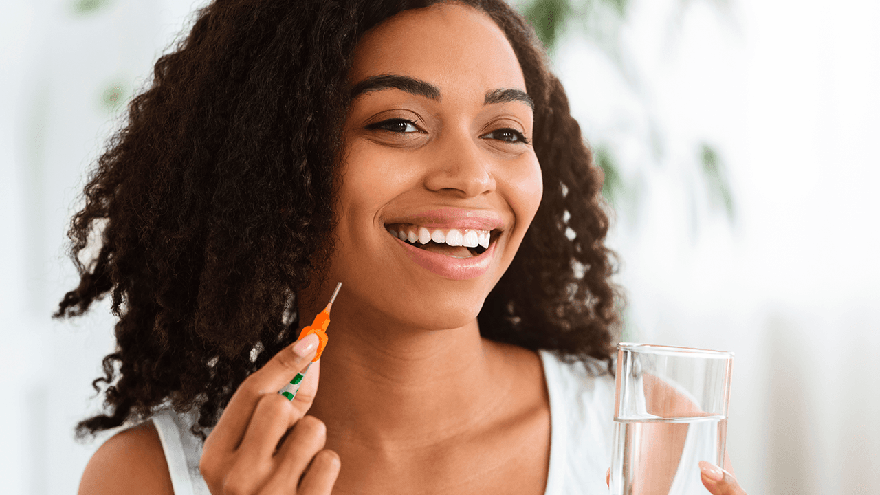 woman ready to clean between her teeth with a TePe Interdental Brush
