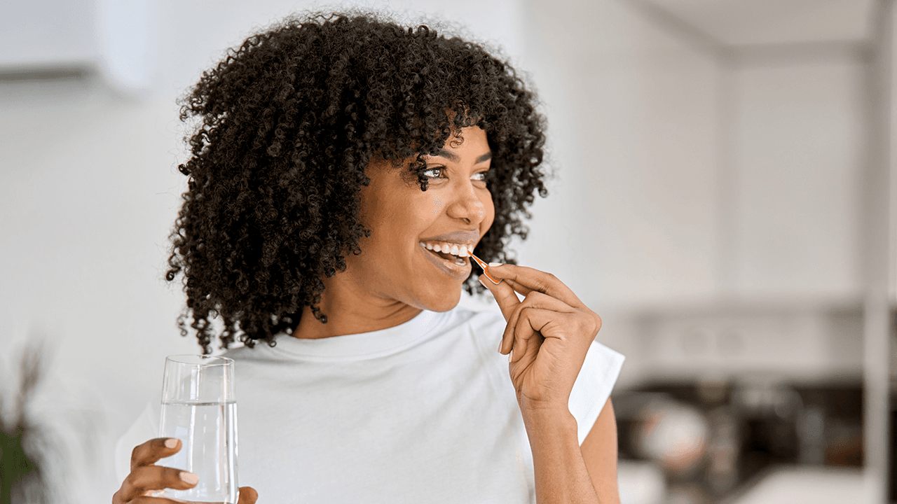 woman using a TePe EasyPick to clean between her teeth