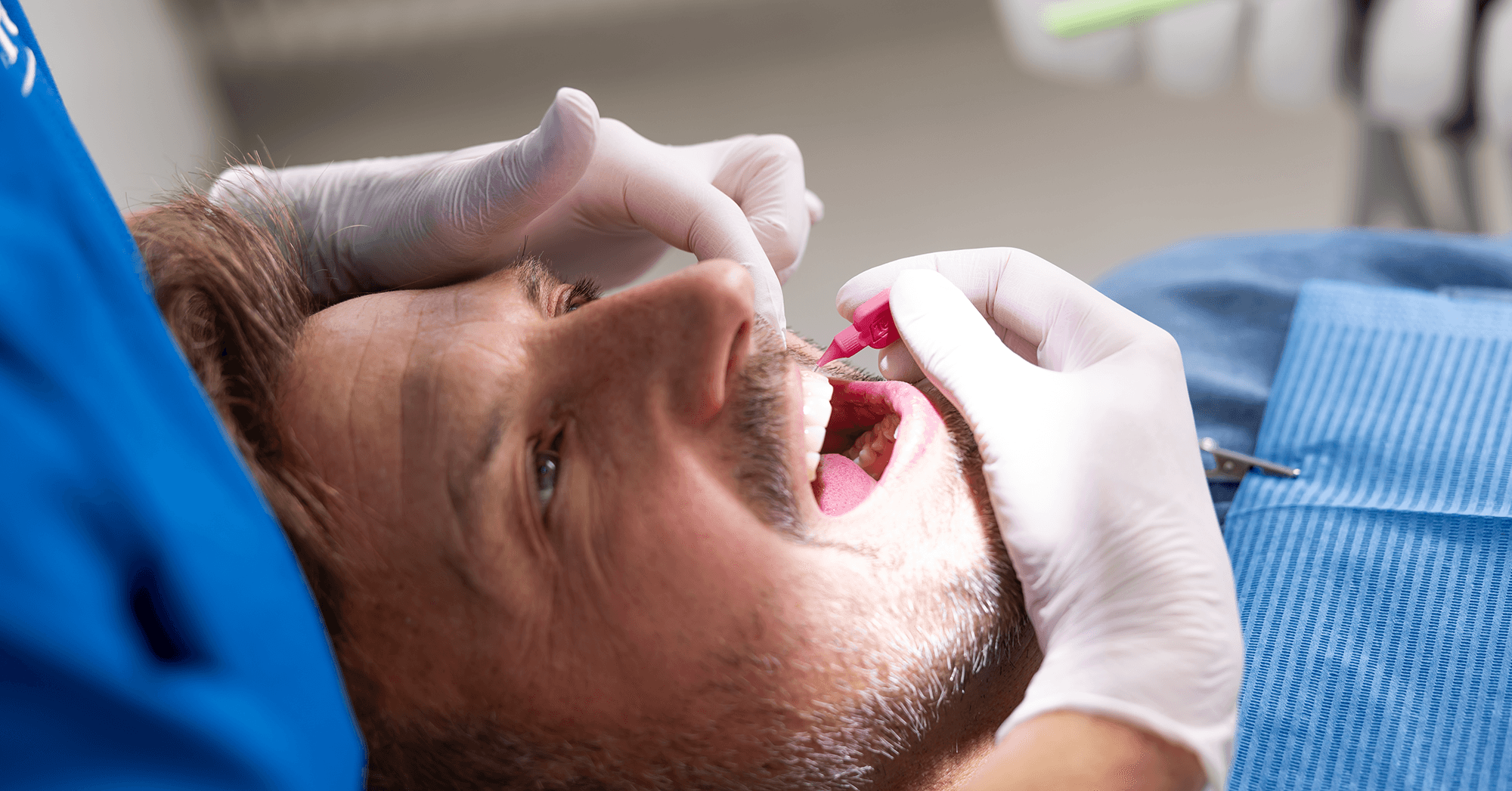 Patient at the dentist cleaning between teeth